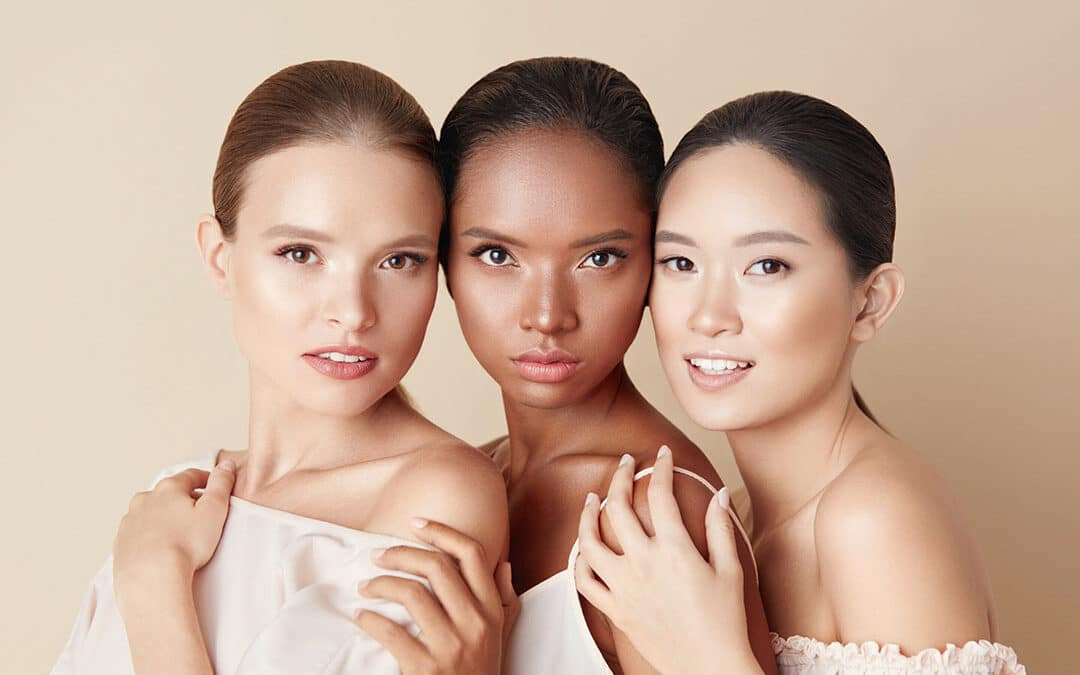 3 women - Beauty. Portrait Of Diversity Models. Mixed Race, Asian And Caucasian Girls Hugs Each Other And Looking At Camera. Different Ethnicity Women With Nude Makeup And Perfect Glowing Skin.